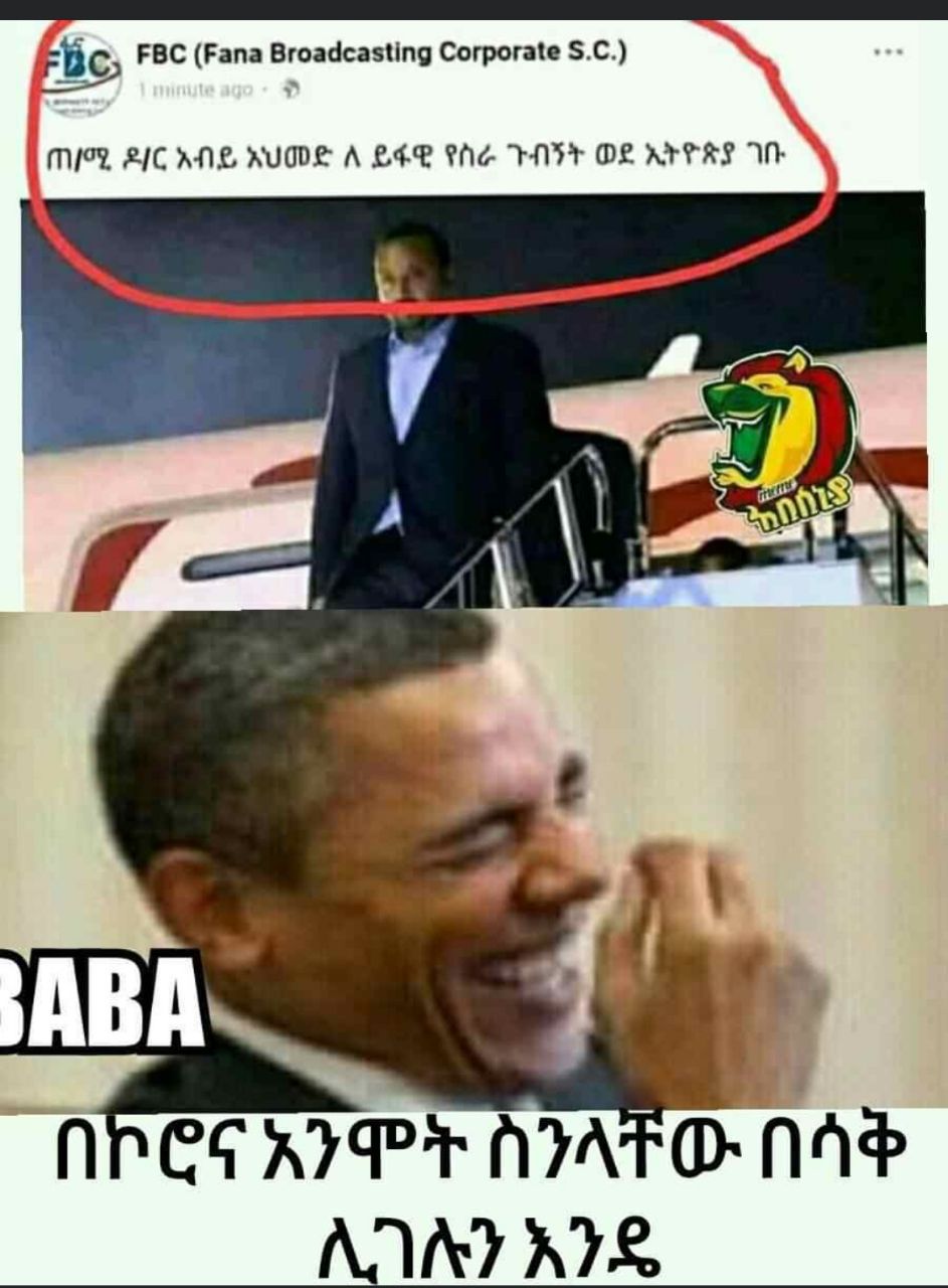 a man in a suit and tie is laughing